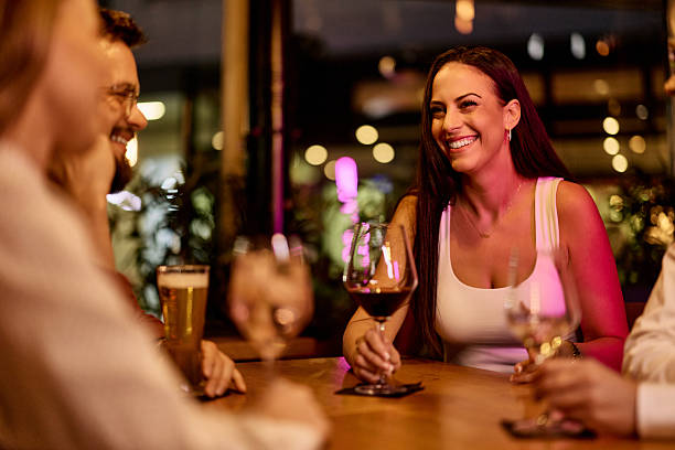 istock Friends Sharing Drinks at a Cozy Restaurant During the Evening 2231442803