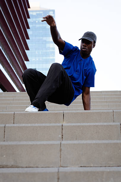 istock Breakdancing youth executing dynamic freeze pose on urban steps, displaying street dance skill with powerful movement and urban energy 2231447158