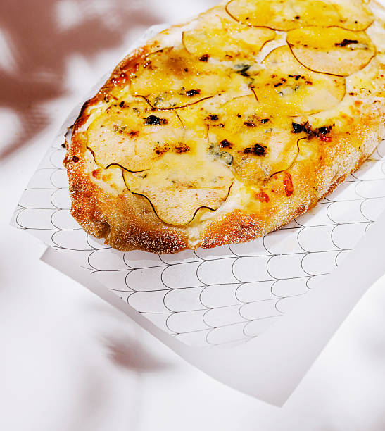 istock Delicious flatbread topped with cheese and potatoes served on a patterned tray 2231447441
