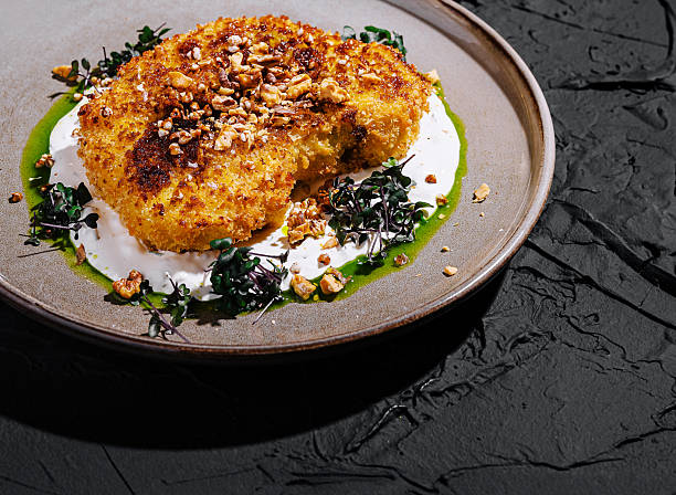Crispy fried dish served on a textured plate with garnishes
