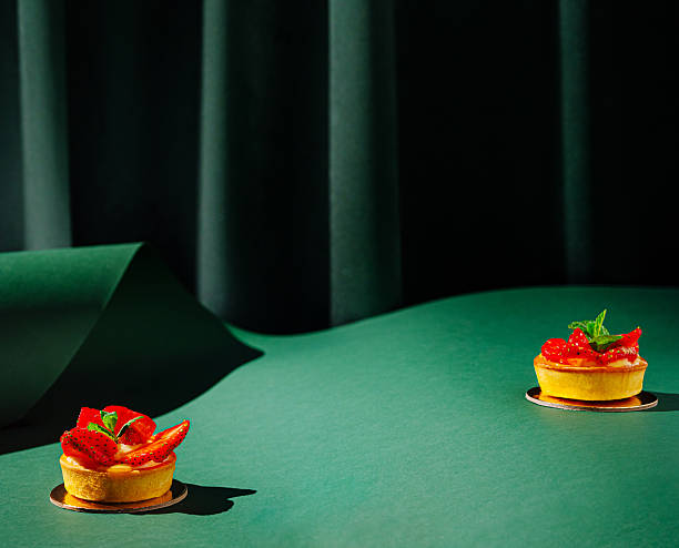 istock Delicious strawberry tarts displayed on a green surface in a creative setting 2231447600