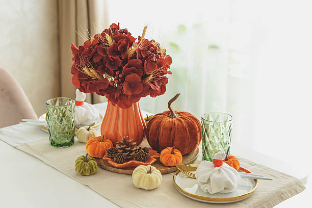 istock Thanksgiving table setting with decorative pumpkins, candles and string lights on white wooden table 2231452817
