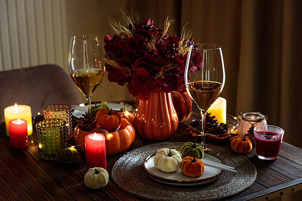 istock Thanksgiving table setting with decorative pumpkins, candles and string lights on dark wooden table 2231452846