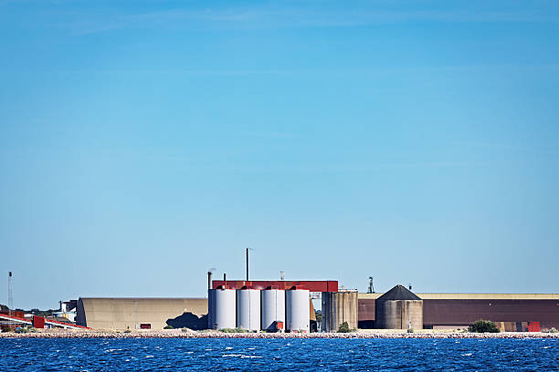 Helsingborg, Scania, Sweden - August 17th 2025:  One of the many manufacturing plants surrounding Helsingborg, a major industrial hub in southern Sweden, seen from the water. The coastal view highlights the city’s strategic location and its role as a key player in Scandinavian industry.