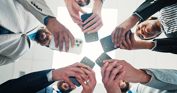 istock Research, colleagues and group with smartphone, office and networking for project on website or app. Browsing, low angle and people with mobile for brand awareness, together and tech for advertising 2231454104
