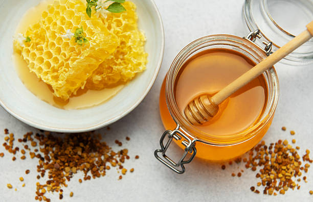 istock Honey, honeycomb and bee pollen creating delicious golden composition 2231456078