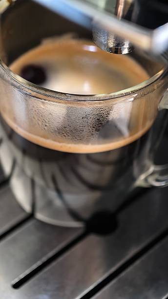 istock Freshly Brewed Espresso in Glass Cup, Macro Shot with Coffee Machine 2231456539