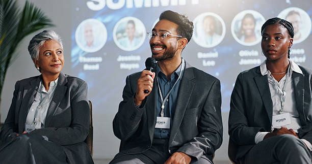 istock Presentation, speaker and panel of people on a stage for discussion, seminar FAQ and conference. Business summit, entrepreneurship expo and man with women with mic for tradeshow, event and convention 2231457596