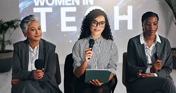 istock Business women, seminar or mic with tablet for presentation, discussion or tech summit at workplace. Female people, employees or group with technology for speech, convention or corporate tradeshow 2231457648