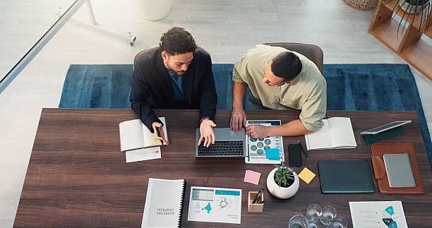 istock Documents, notebook and business men in office for meeting with finance data, statistics or graphs. Paperwork, writing and top view of male financial managers plan for company investment with charts. 2231458390