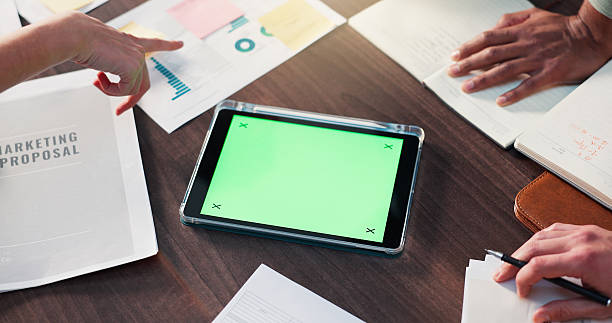 istock Office, documents and hands with tablet, green screen and meeting for data analysis or mockup space. Above, charts and people with paperwork for stats, financial analyst and colleagues with report 2231458421