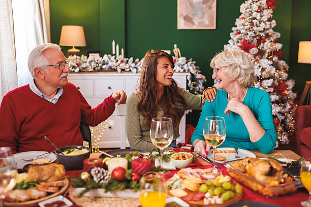 istock Daughter having Christmas dinner with senior parents at home 2231458559