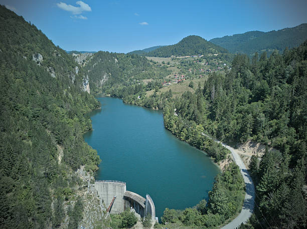 Small mountain lake among green forest hills aerial view, Tara mountain