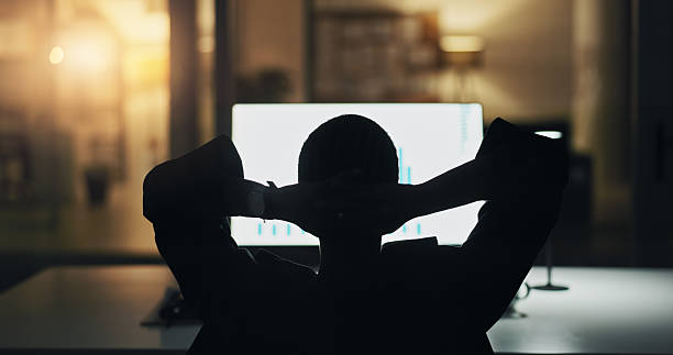 Computer screen, relax or stretching with business person at night, finish trading or graphs. Peace, back or calm worker in office or stock broker complete investment analysis for finance on overtime