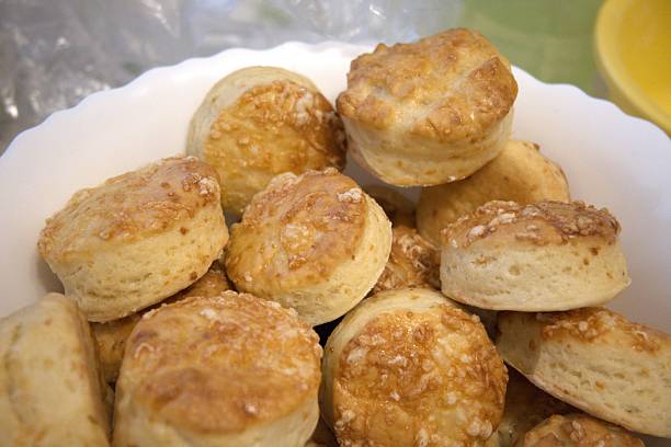 Freshly baked Hungarian cheese scones served in bowl, traditional homemade pastry close-up.
