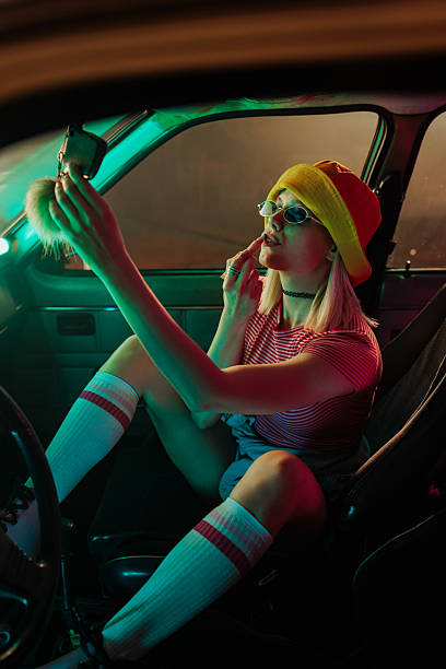 istock Retro girl doing makeup in car. 2231470465