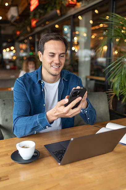 istock Young adult freelancer working remotely from a cafe 2231471829