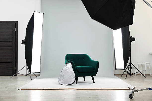 istock Professional lighting equipment setup and armchair in modern photo studio 2231472521
