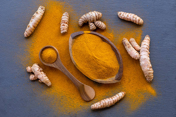 istock Fresh and ground turmeric root on a slate background 2231473254