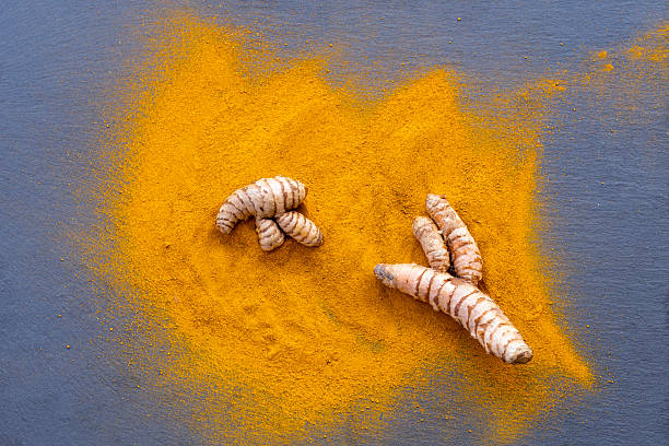 istock Fresh and ground turmeric root on a slate background 2231473259