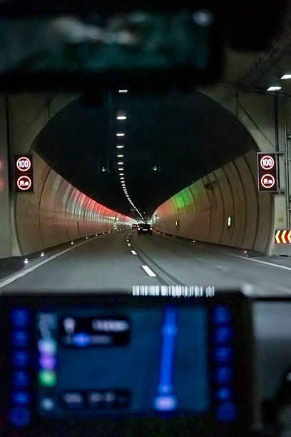 istock Traffic in modern road tunnel with red illuminated signs 2231475071