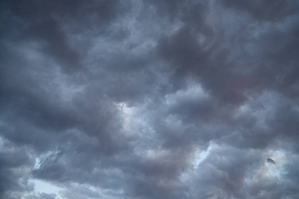 Stratocumulus clouds, dark clouds with barely visible light streaks resembling traces of an explosion.
