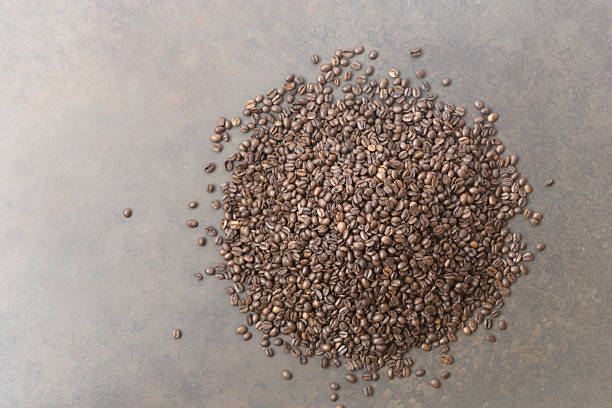 istock Coffee beans on the dark wooden background 2231478317