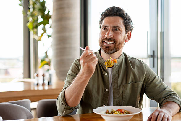 istock Happy customer enjoying a healthy meal in a restaurant 2231479778