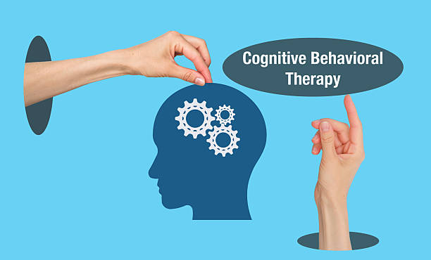 istock A blue background with a head and hands on it. The head has three gears on it. The words Cognitive Behavioral Therapy are written below the head 2231479918