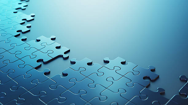 A close-up of a blue jigsaw puzzle, featuring missing pieces and a gradient background symbolising ideas like challenge, completion, and connectivity.