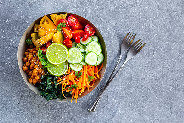 Buddha bowl - vegetarian bowl with chickpeas and fresh vegetables on the grey background top view copy space for text