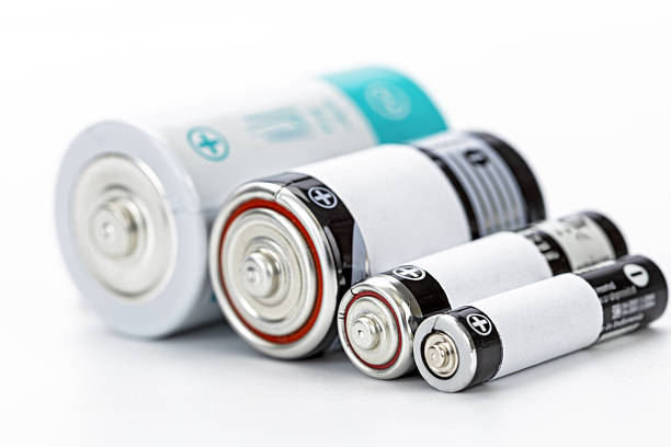 A various size battery cylindrical battery alkaline battery rechargeable battery power supply energy storage close up metallic white background technology concept