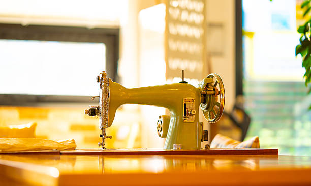 A vintage manual sewing machine on an old wooden table. High quality photo