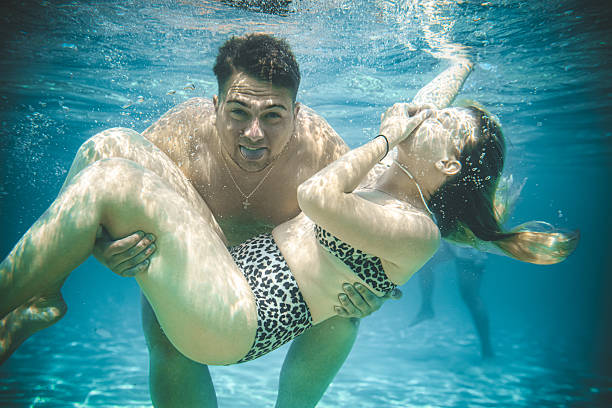 istock Lovely Boyfriend Holding Girlfriend Underwater Looking Joyful 2231482219