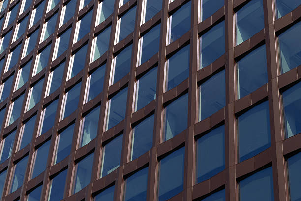 istock Modern office building facade with brown frames and reflective glass windows 2231483910