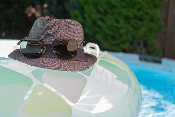 Swimming tires with hat and sunglasses in the pool