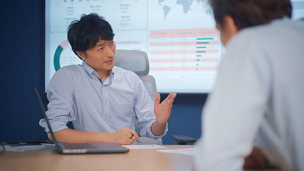 istock Japanese Marketing Manager Analyzing Performance Metrics on Screen During Business Meeting. 2231487571