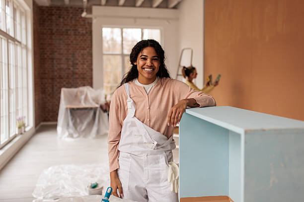 istock Young Female Painter Renovating Wooden Cabinet 2231489176