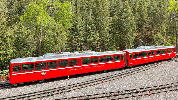 With people looking out the windows, the “Summit” steam engine and passenger car descends near the Jacob's Ladder trestle on the historic Mount Washington Cog Railway in New Hampshire on September 3, 1998.
