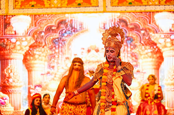 Happy little Indian boys dressed up as Krishna for the Janmashtami celebration and looking his self in the mirror and having fun.