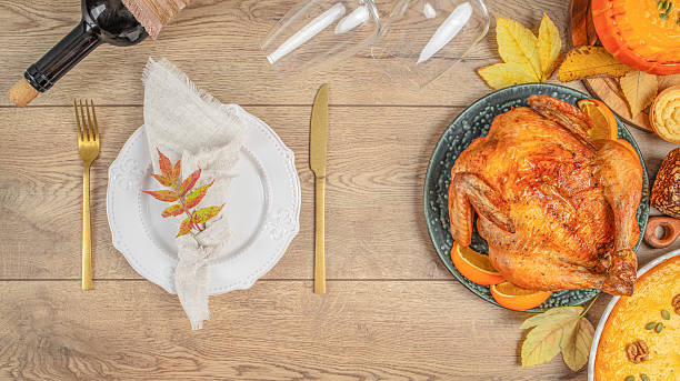 istock Elegant Thanksgiving dinner table setting with roasted turkey and autumn decorations. Long banner format. top view 2231495610