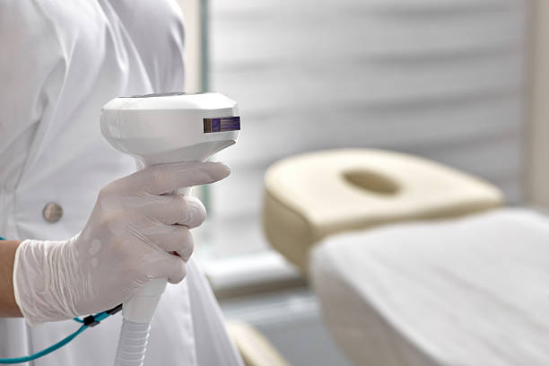 istock Beautician holding Lumecca device with intense pulsed light IPL technology for photorejuvenation of a woman's body and removal of brown spots and freckles, close-up 2231500973