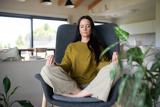 istock Woman meditating with hands in prayer position 2231502825