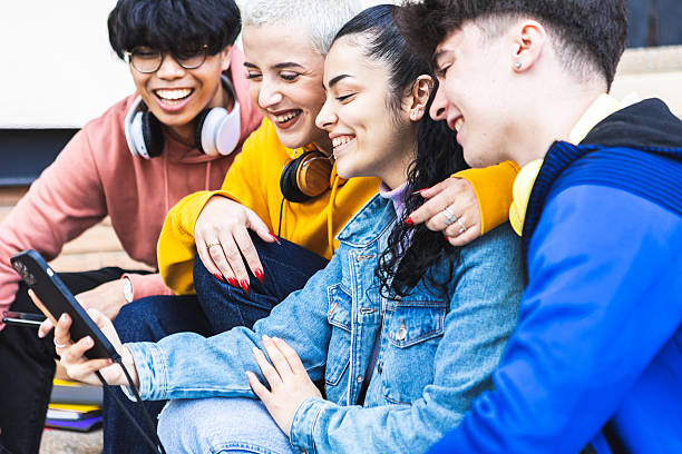 istock Multiracial young student friends having fun watching social media content on app 2231504068