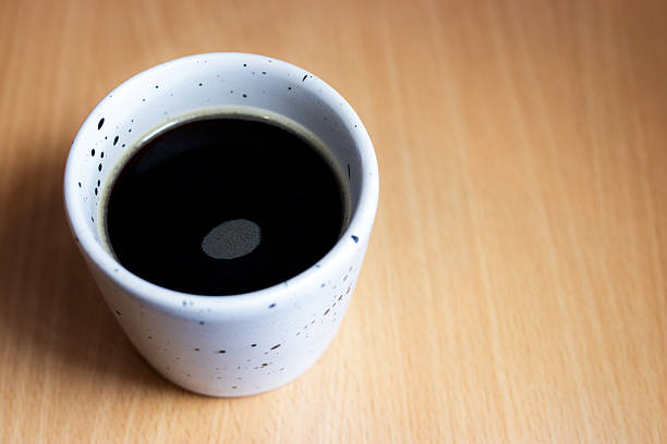 Fresh aromatic coffee on a wooden kitchen table. High quality photo