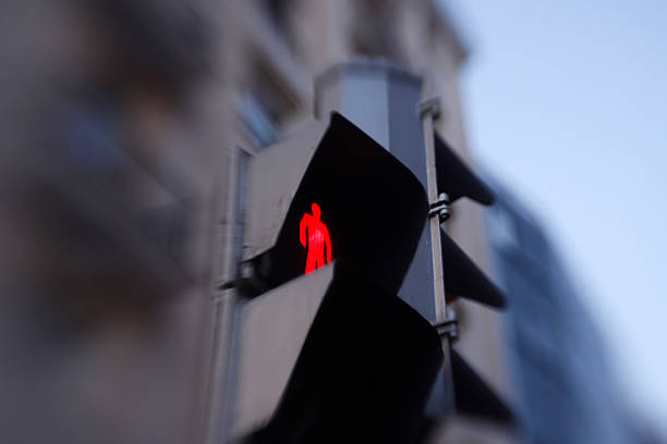 istock Red pedestrian light showing stop signal in urban setting 2231514694