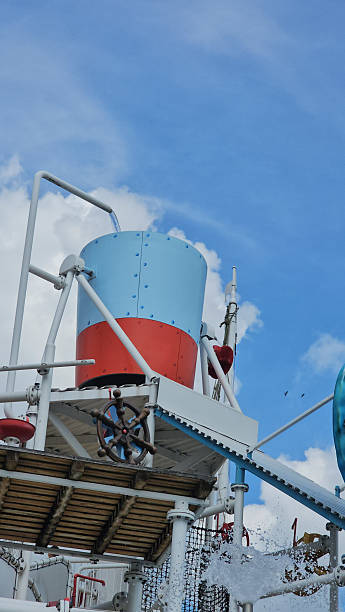 Water storage tank on a platform under a blue sky with clouds