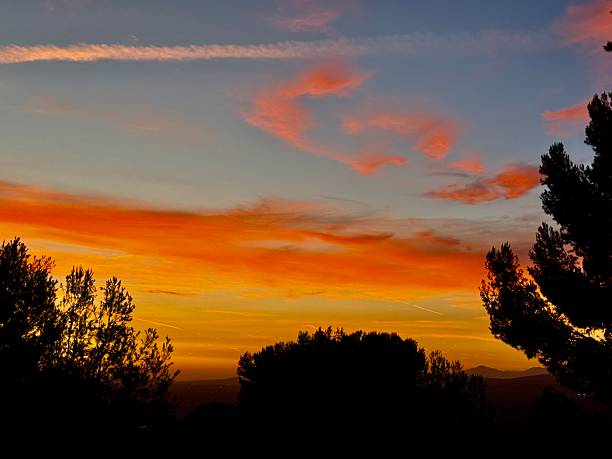 Walking down hill and enjoying this amazing sunset that has beautiful fairy colors on a blue sky. It is located in Anaheim Hills, California. During Summer Season.