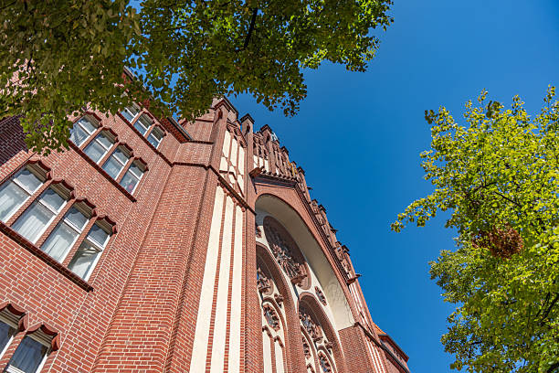 istock A red-brick church facade rises against a clear blue sky. 2231527903