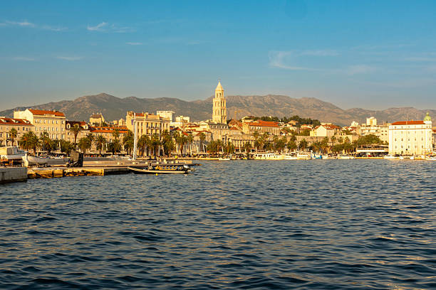A photograph of the city of Split, Croatia, in which the bell tower, dominant in the picture, is in the Old Town. The photograph shows the Adriatic Sea leading up to the port of Split, and was taken during blue hour. The picture was created from above the city, on Marjan Hill to the west of the city. To the east, and dominating the background, are the  Mosor Mountains, which are part of the Dinaric Alps.